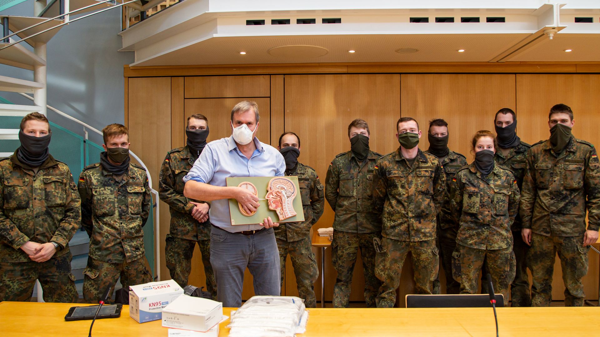 Dr. Bernhard Junge-Hülsing (vorne) und die Soldat*innen bei der Einweisung zur Durchführung von Antigen-Schnelltests.